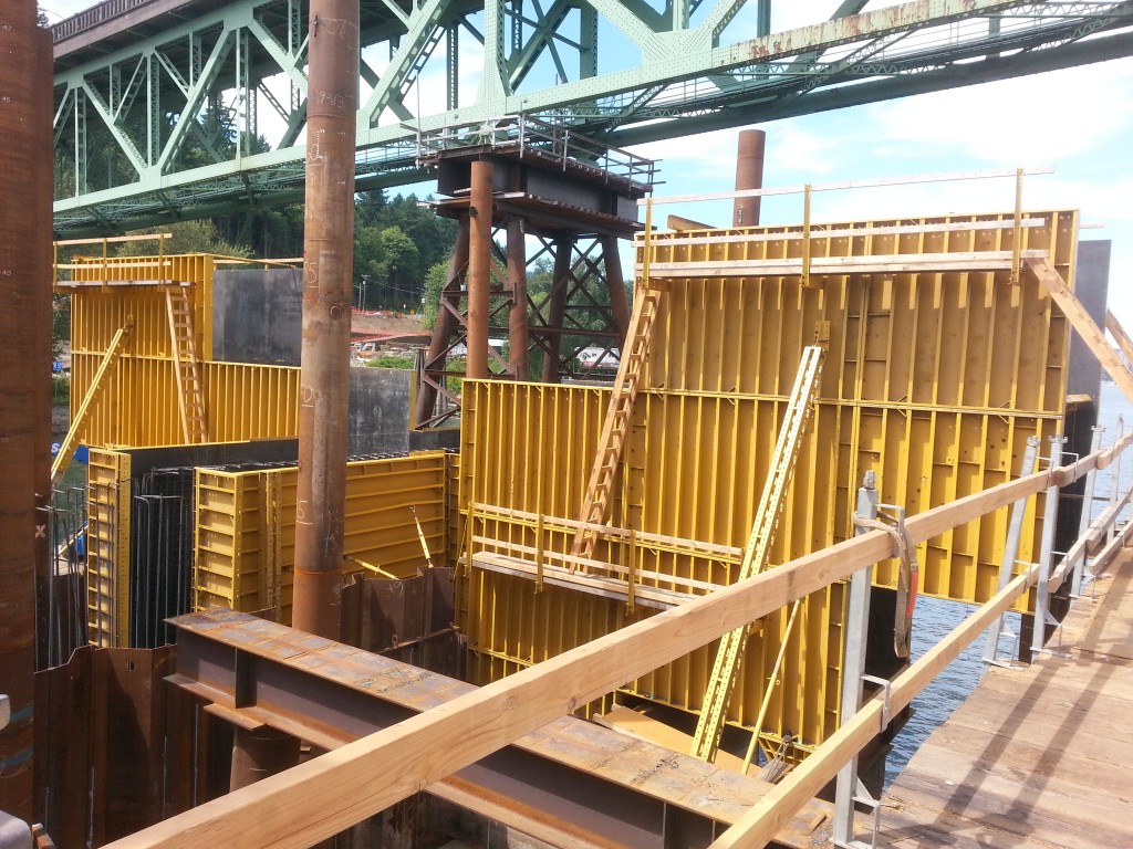 It looks like there is a lot going on under the bridge (and of course there is) but most of the construction revolves around building the casting boxes that will shape the poured concrete.  The yellow panels, gigantic as they are, are just the walls of a concrete mold.